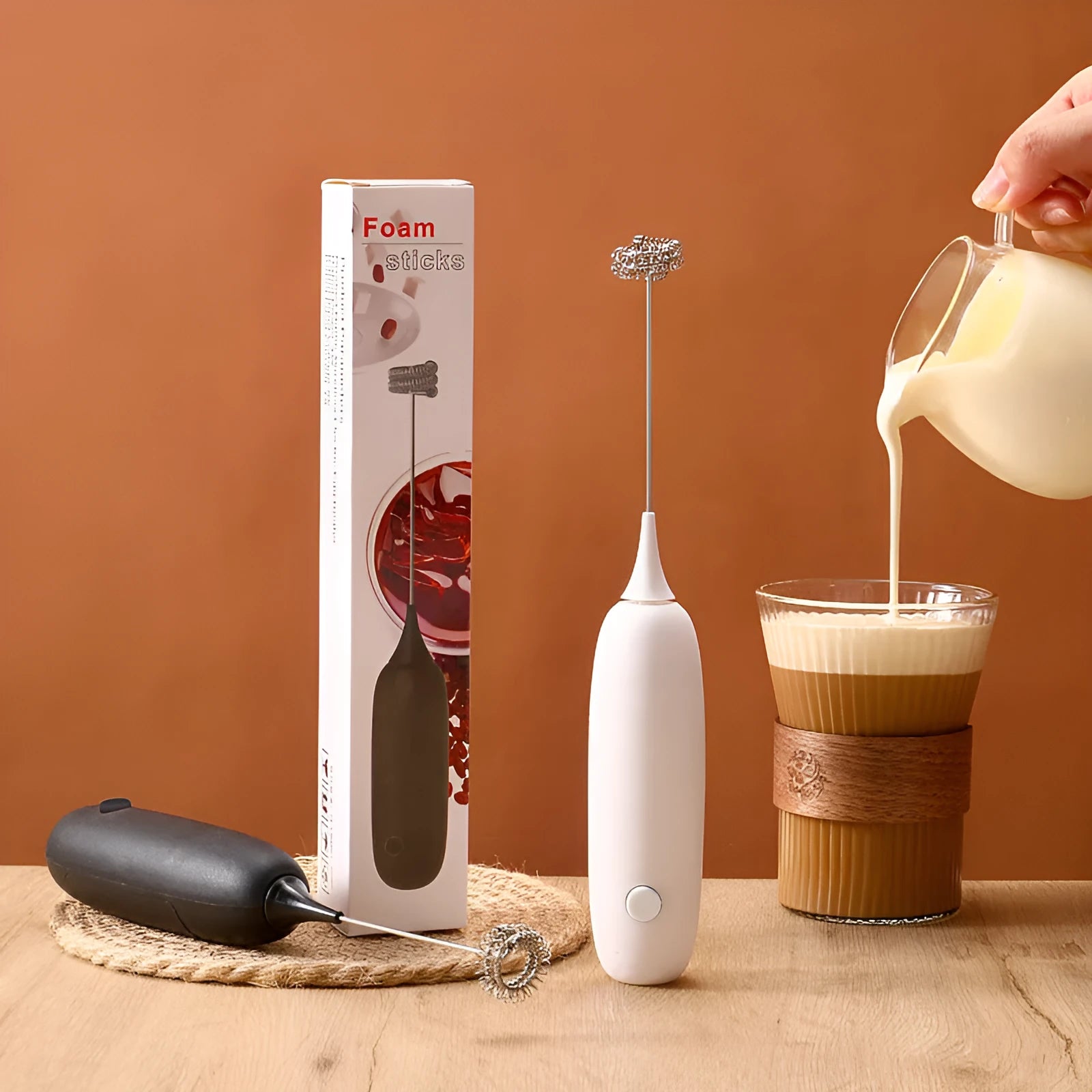 Black and white hand-held electric milk frother blender with modern design