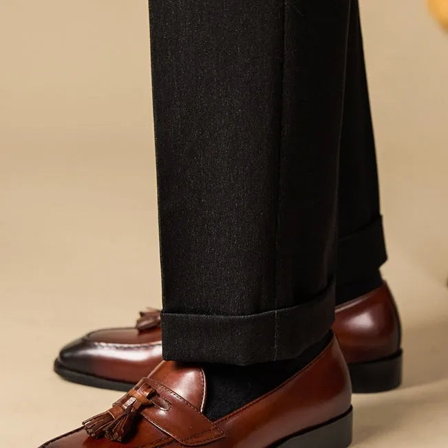 Black and brown business casual loafers with tassel detail and genuine leather upper