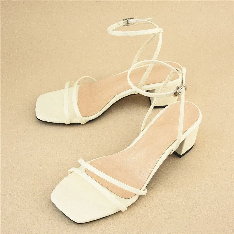 Beige women's sandals with a stiletto chunky heel, square toe, and an ankle buckle strap.