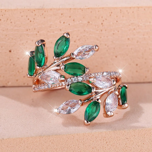 Adjustable leaf ring with horse eye zircon stone in rose gold finish on wooden background