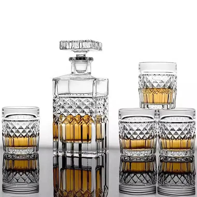 Crystal glass wine set with retro style cups and bottle on table