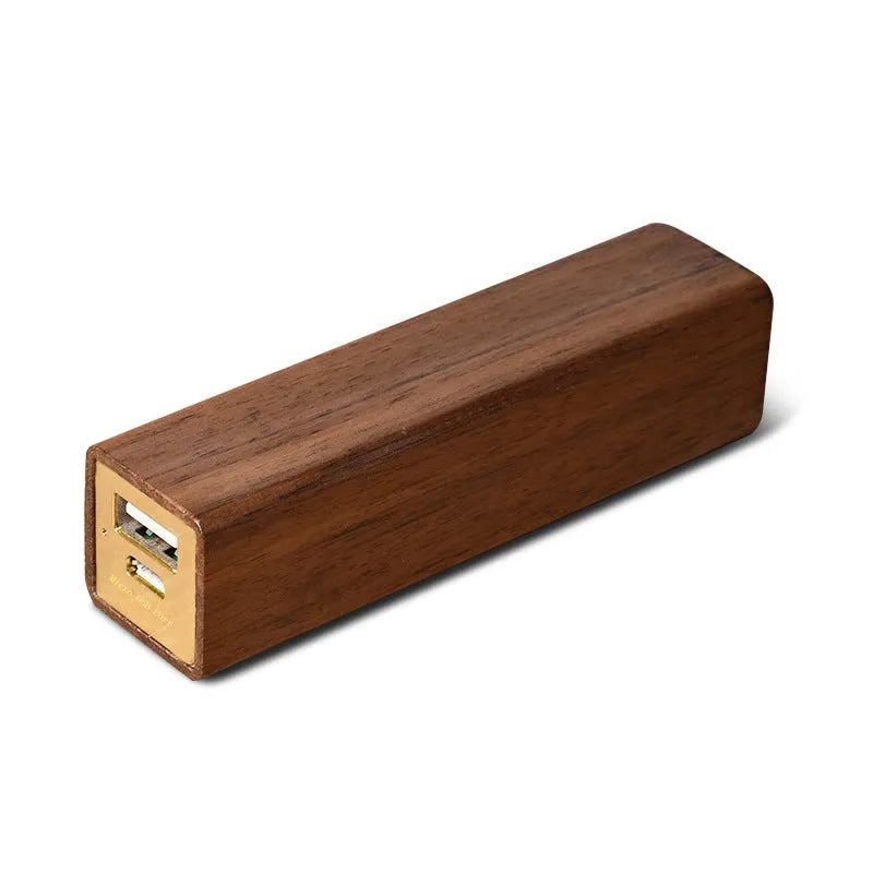 Portable power bank with brown walnut wood shell showing charging ports
