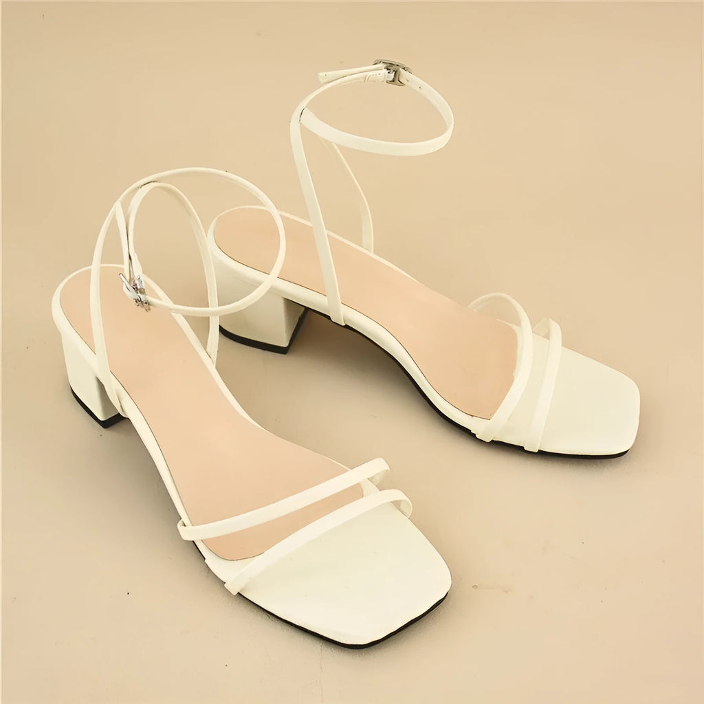 Beige women's sandals with a stiletto chunky heel, square toe, and an ankle buckle strap.