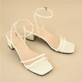 Beige women's sandals with a stiletto chunky heel, square toe, and an ankle buckle strap.