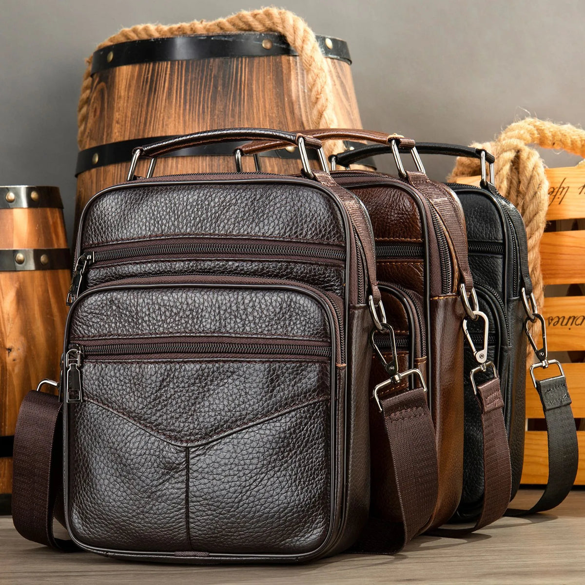 Men's top grain leather crossbody bag in brown with stitching detail and expandable side panels