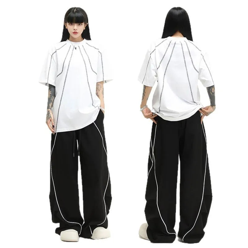 Black and grey striped men's wide-leg pleated sports pants on a hanger.