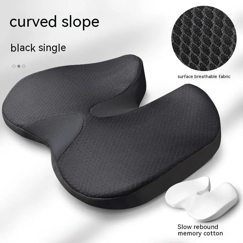 Curved bevel seat cushion in beige colour on a car seat, designed for tailbone support.