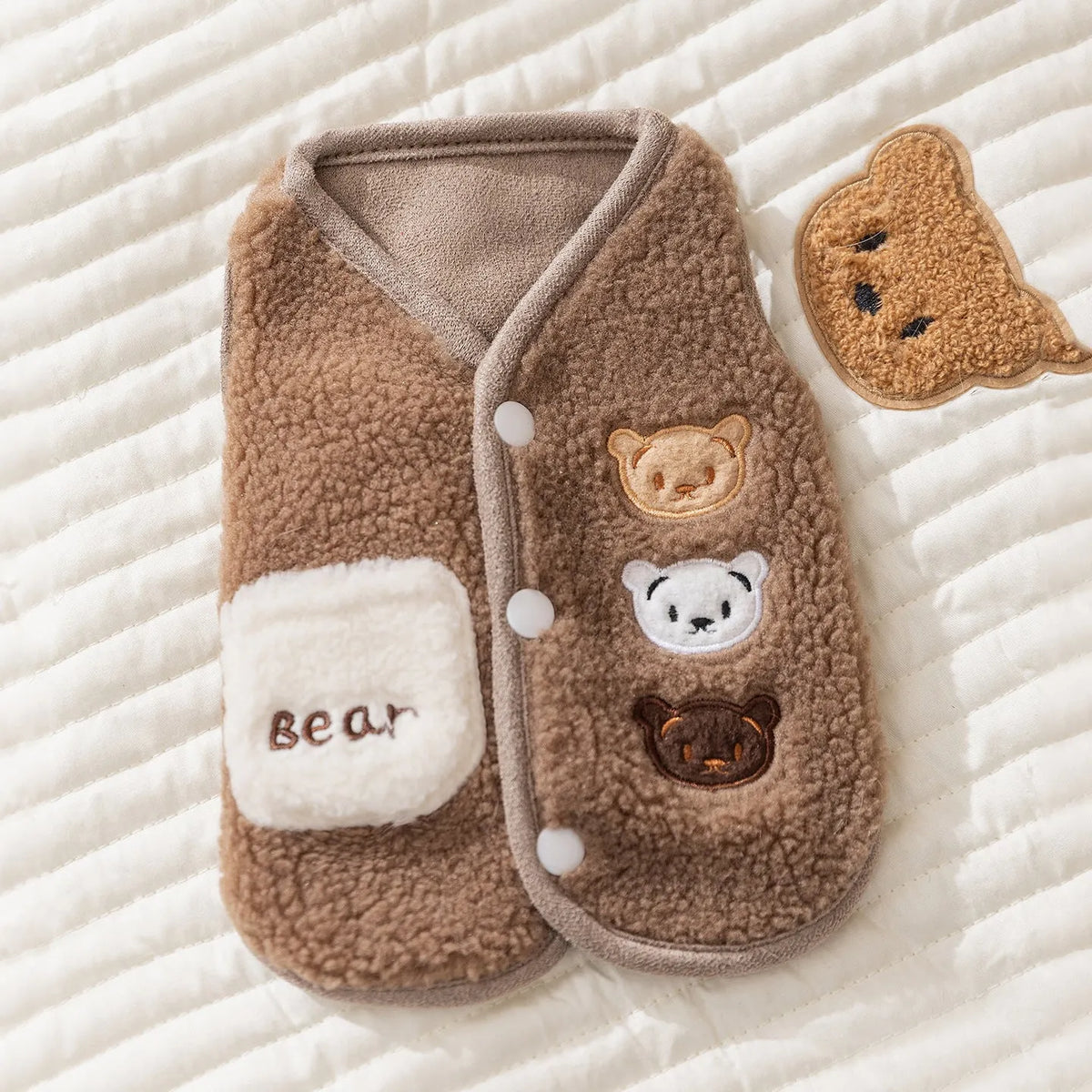Warm fleece dog jacket with bear embroidery for small breeds, side-button closure, available in brown and white.