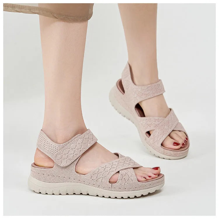 Plus size flat sandals in apricot with Flyknit upper, PVC sole, and Velcro strap.