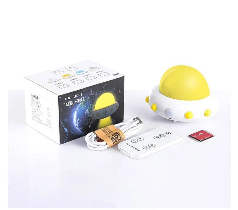 Remote control UFO shaped bedside night light in blue, pink or white colours on a table