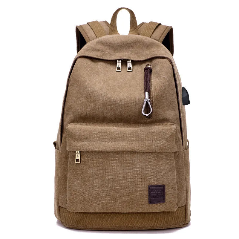 Canvas backpack with USB charging port showing computer compartment and multiple pockets