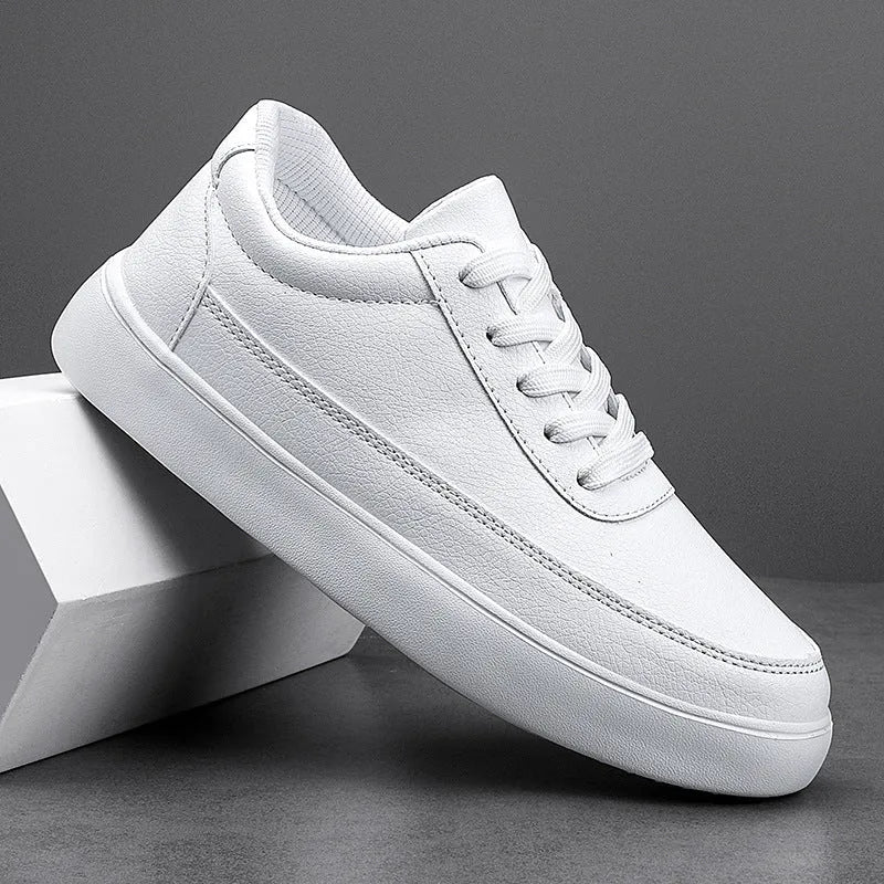 Women's white leather flat lace-up casual shoes on a plain background.