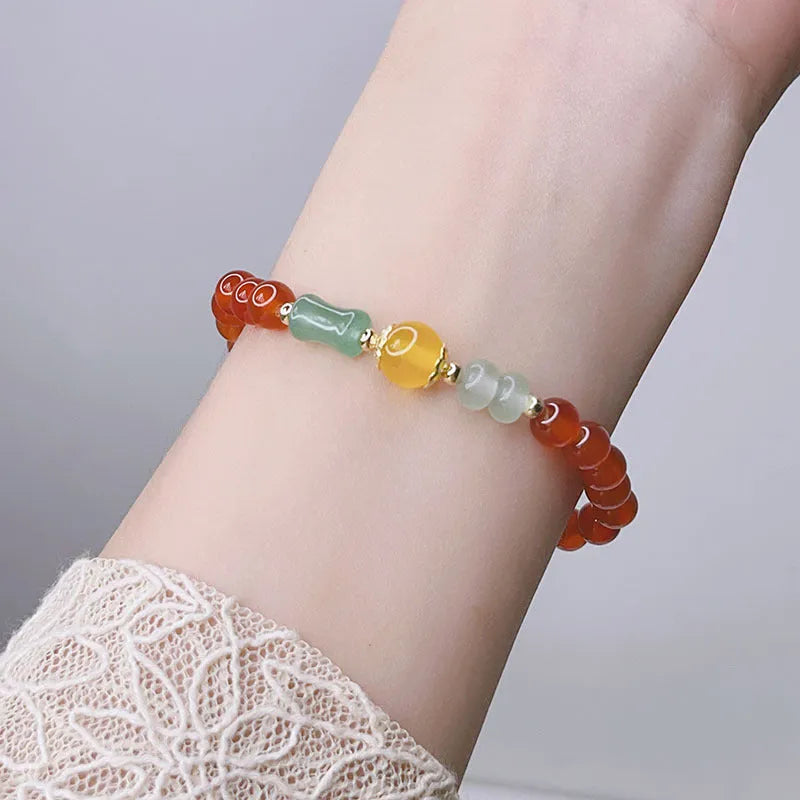 A red agate bracelet for women with a manual crafted dragon design in Chinese style.