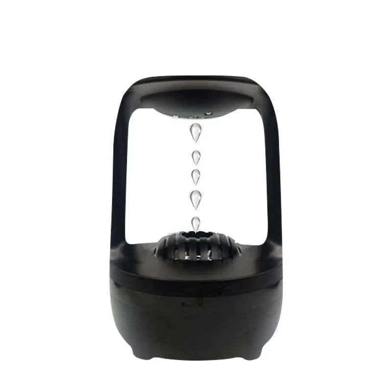 Anti-gravity humidifier with water droplet effect on desk next to USB cable