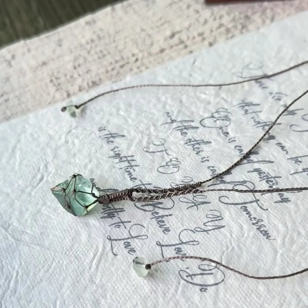Artificial crystal rough labradorite-style pendant necklace with O-link chain on display