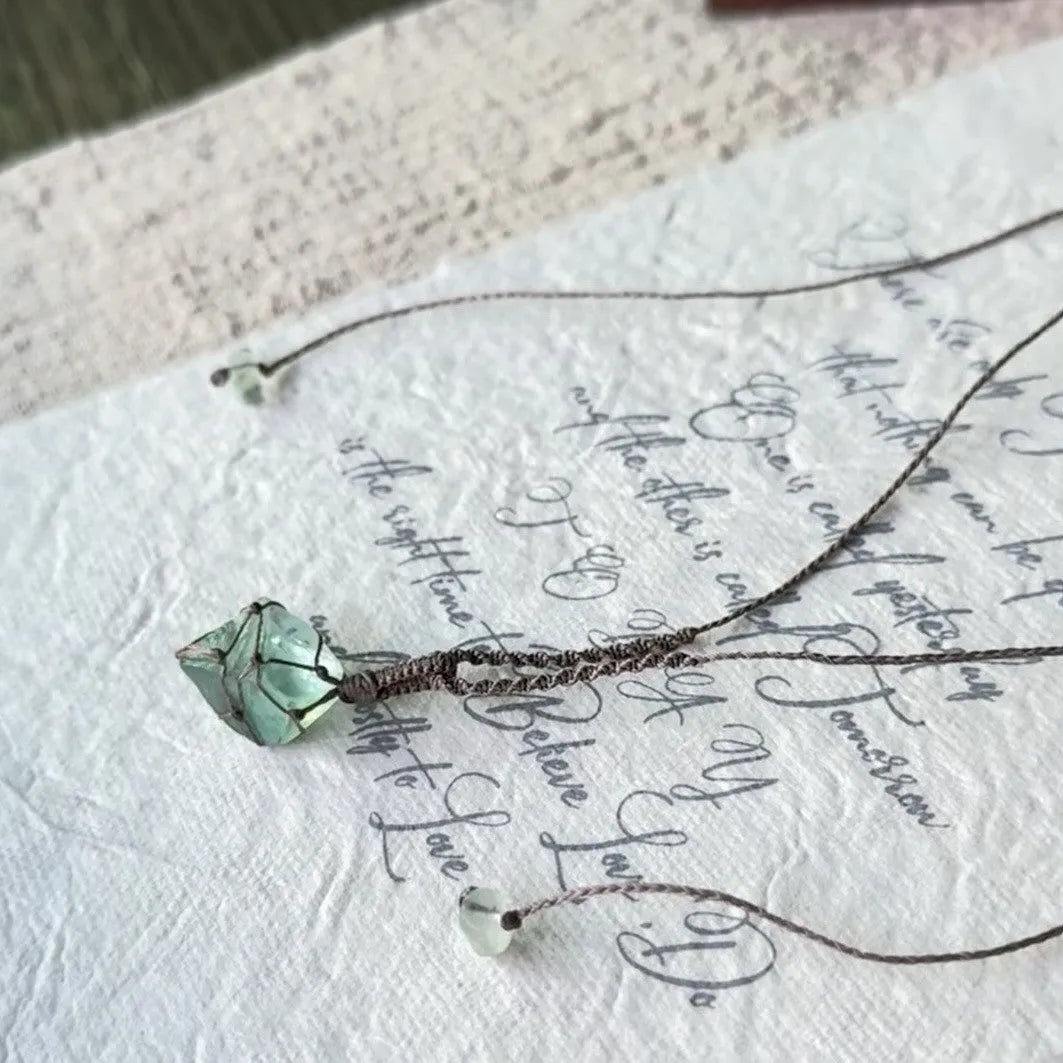 Artificial crystal rough labradorite-style pendant necklace with O-link chain on display