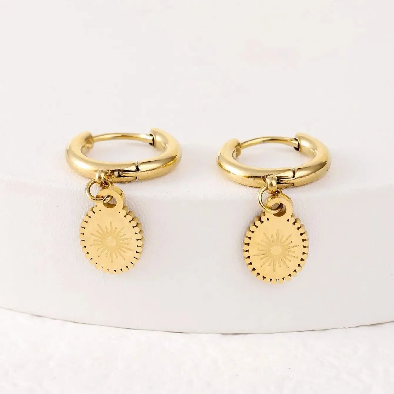 A pair of geometric stainless steel ear button earrings with an ellipse detail, shown in colour XY-EH005.