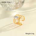 Gold electroplated stainless steel ring with zircon details in heart and geometric shapes on a grey background.