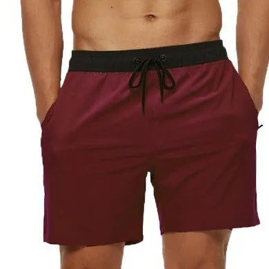 Men's blue athletic shorts with a drawstring waist, zipper pockets, and visible stitching detail.