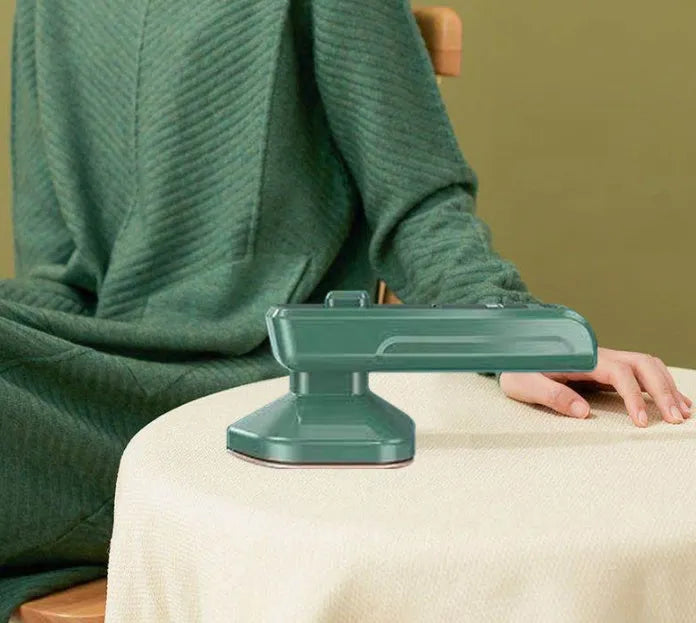 Dark green portable hanging steam iron with ceramic panel and handheld design