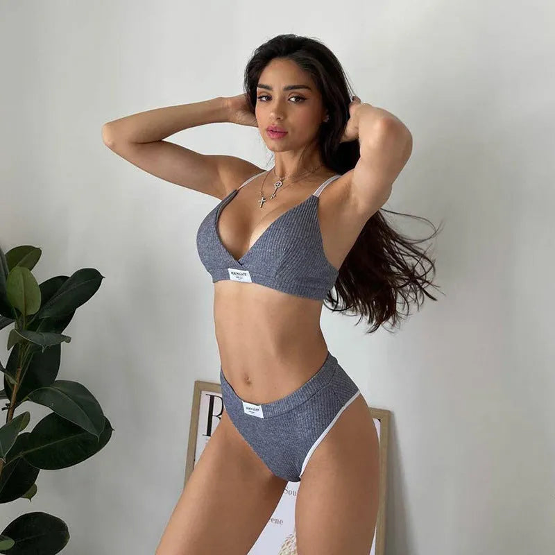Women's grey polyester bikini set with embroidery detail and contrast binding, showing sleeveless top and shorts-length bottoms