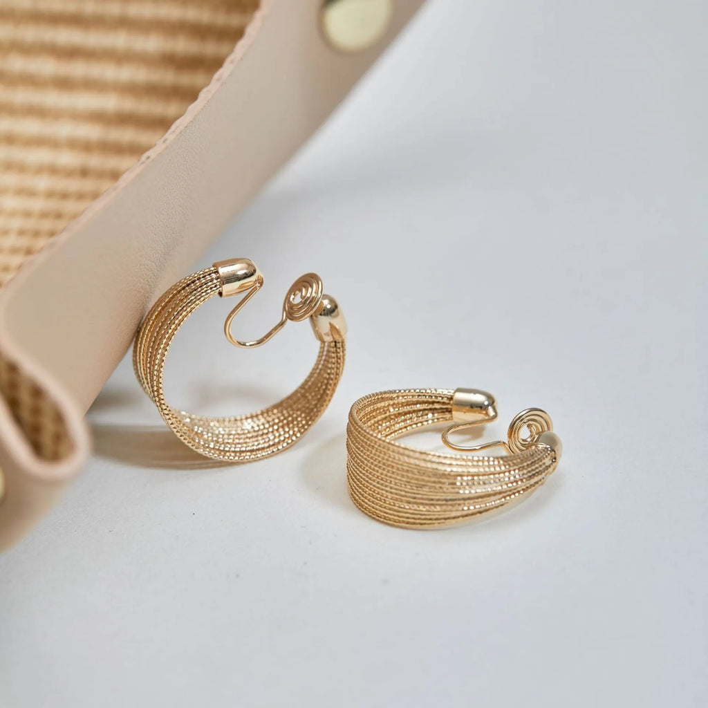 Geometric copper earrings with electroplated silver or gold finish, shown as stud and clip-on styles