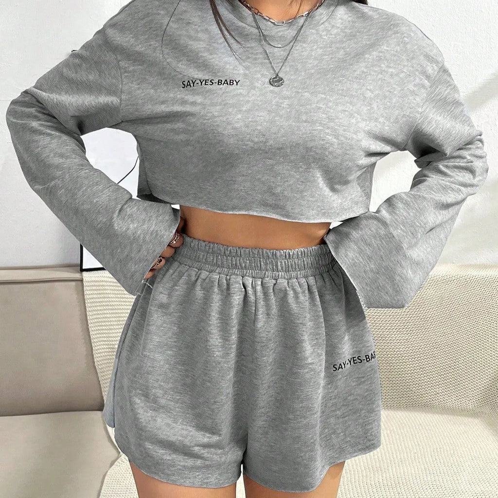 Grey women's long-sleeved t-shirt and matching shorts loungewear set laid flat.