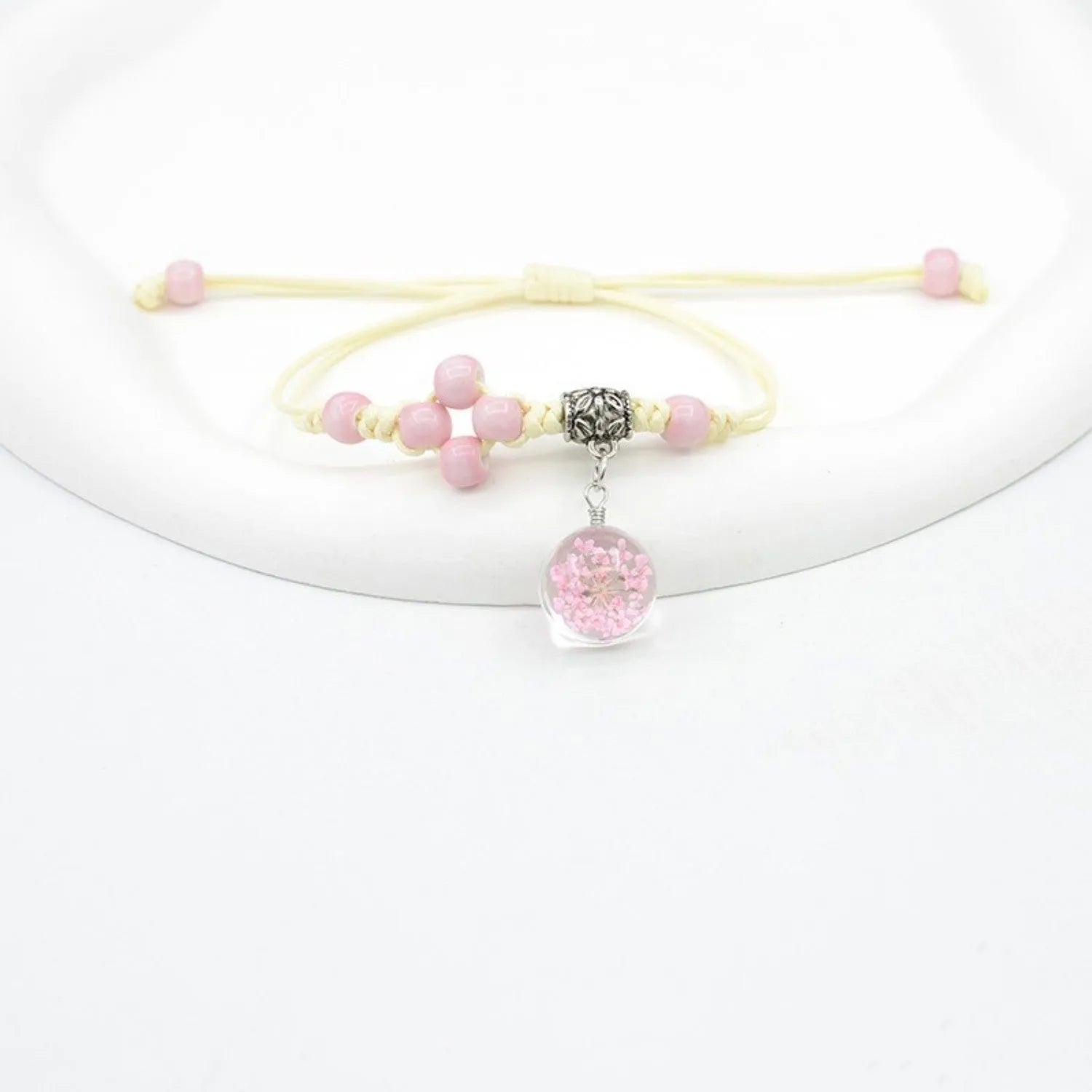 Glass dried flower bracelet with hand-woven beads containing real preserved flowers in various colours