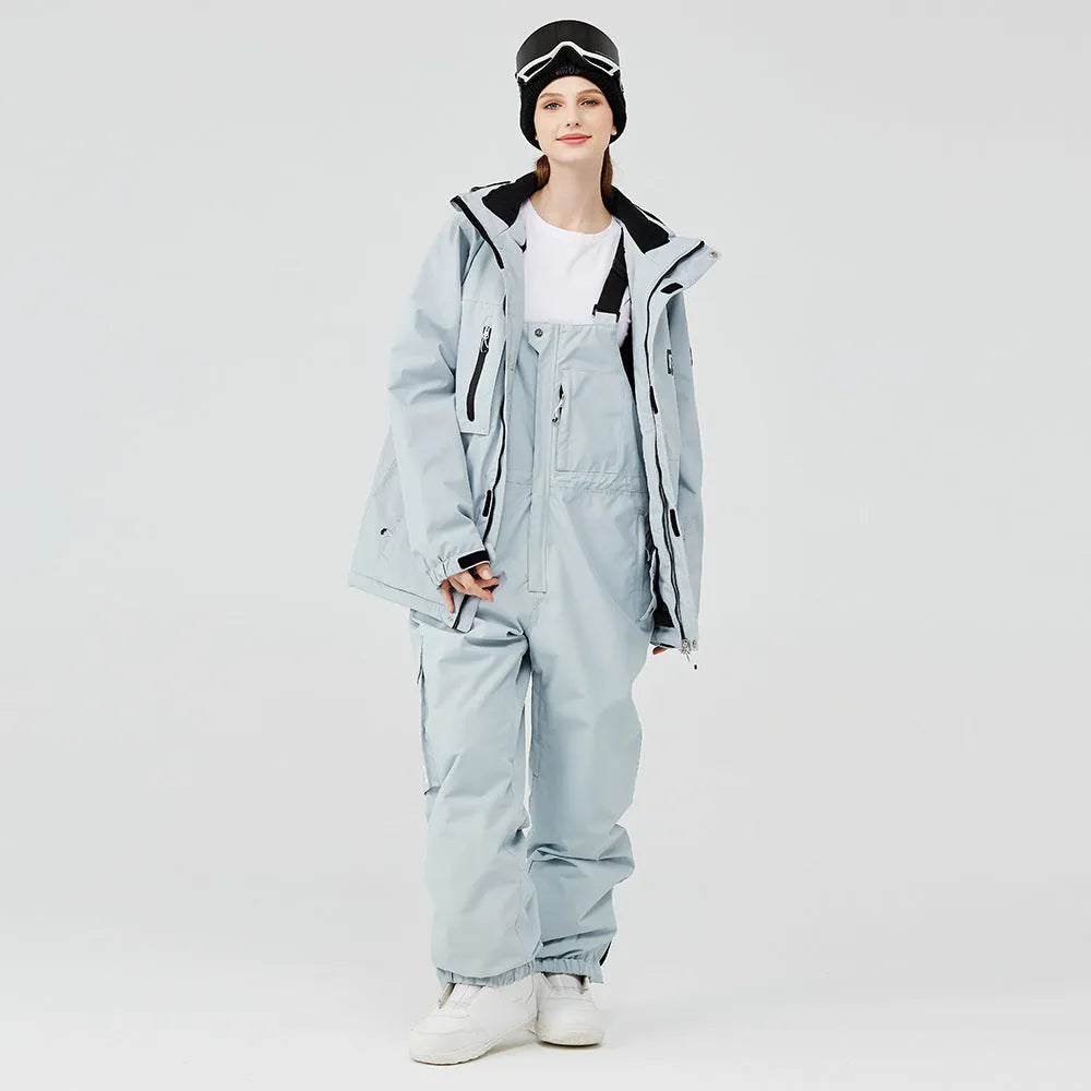 Blue and black two-piece ski suit for men and women on snowy mountain background