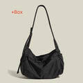 Waterproof nylon messenger bag in black colour showing horizontal square shape and shoulder strap