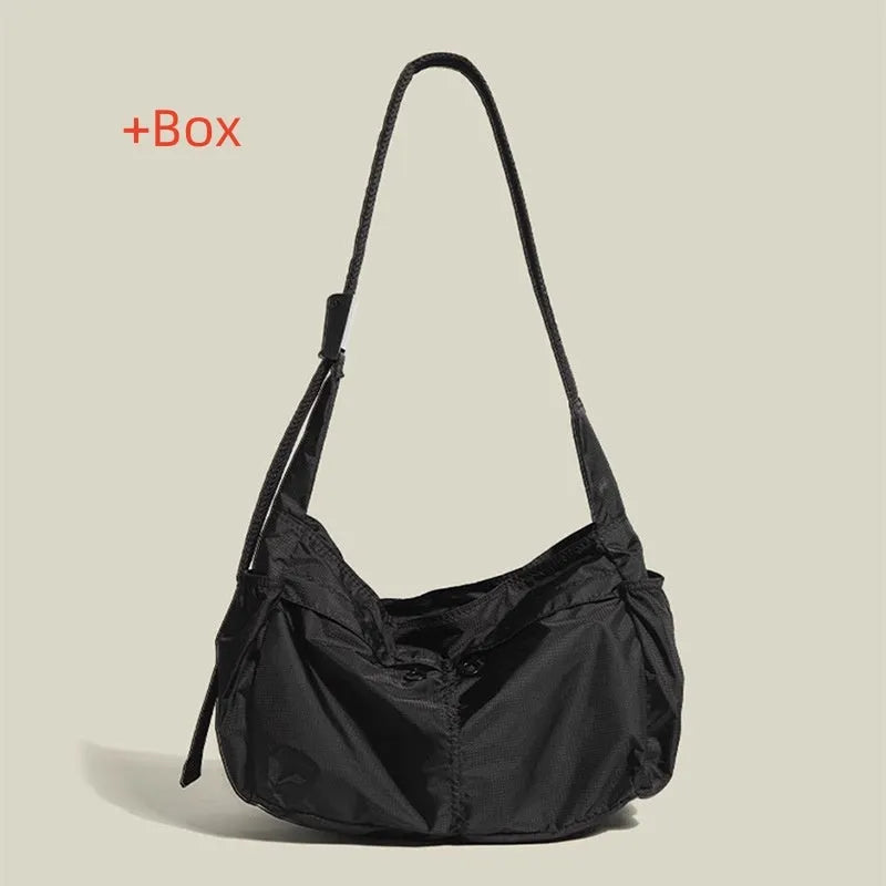 Waterproof nylon messenger bag in black colour showing horizontal square shape and shoulder strap