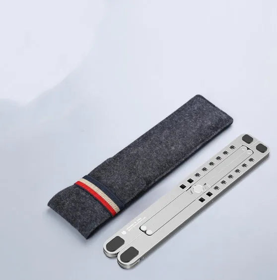 Foldable aluminium laptop stand in silver, shown supporting a laptop at an angle.