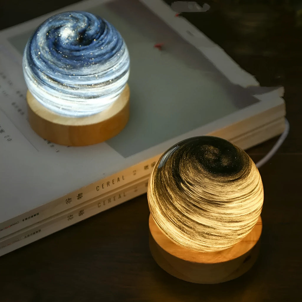 Modern planet-themed USB night light with dimming on a base, showing multiple colour options.