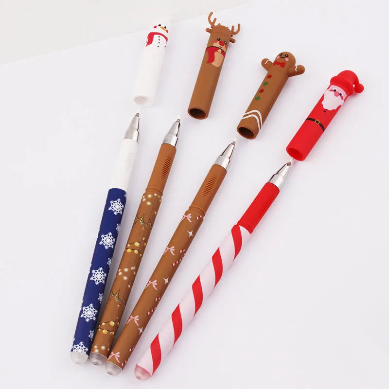 Four Christmas-themed erasable gel pens with Santa, gingerbread man, elk, and snowman designs on a white background