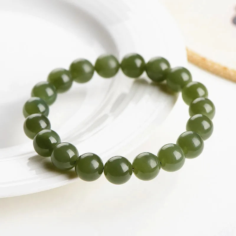 Polished Hetian jade ball bracelet showing ice-clear beads on a wrist, demonstrating deep clear water colour.