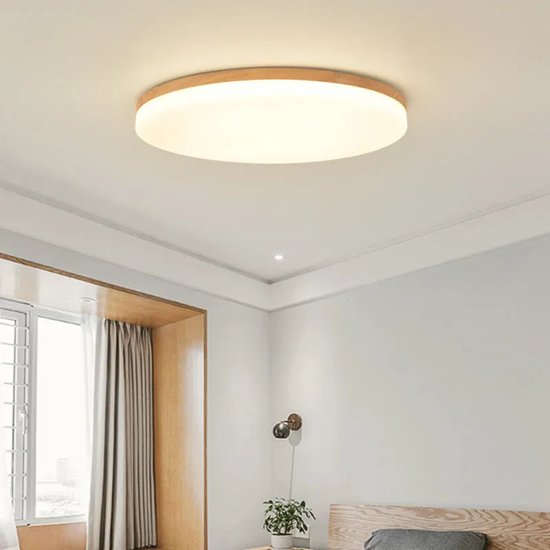 Japanese minimalist ceiling lamp with a wood art body and white acrylic shade in three available diameters.