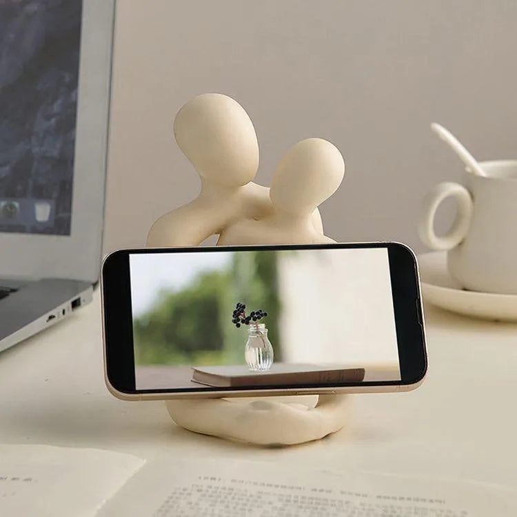 Modern minimalist resin statue of a loving couple in gold or milky white finish.