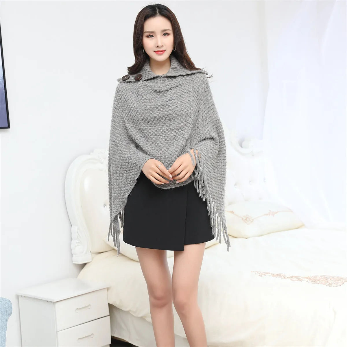 Women's sleeveless knitted cloak shawl with dot pattern in apricot colour