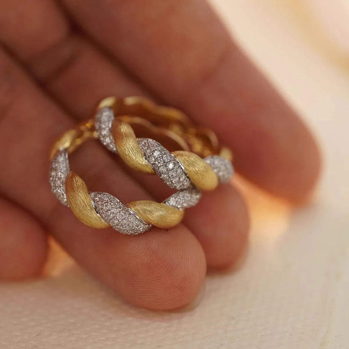 S925 sterling silver twist ring for women, yellow gold finish, geometric pointed band on white background