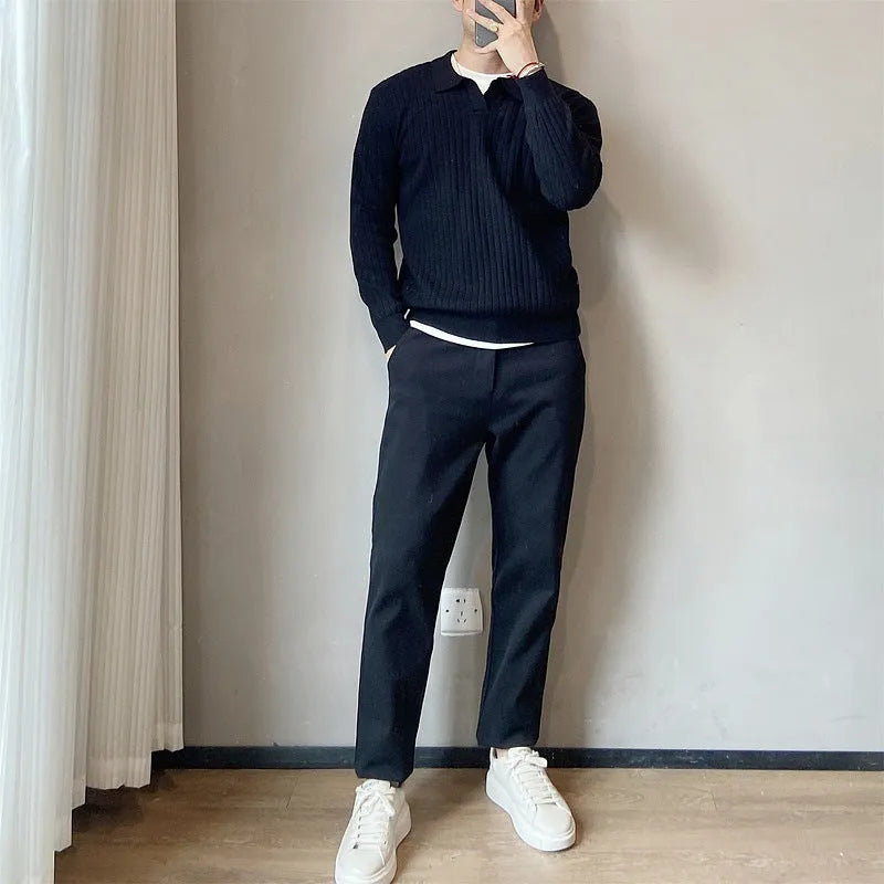 Men's loose grey knitted pullover sweater with long sleeves on a hanger.