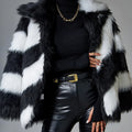 Women's grey faux fur coat with black contrast lapel and a large detachable faux fur collar.