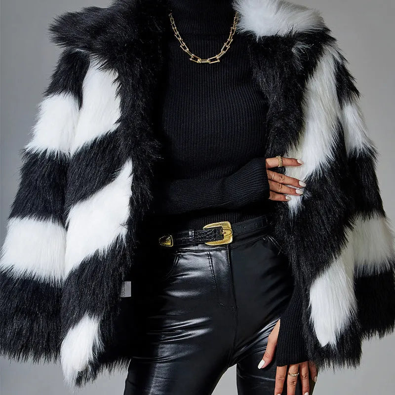 Women's grey faux fur coat with black contrast lapel and a large detachable faux fur collar.
