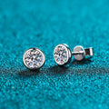 Gold-plated geometrical stud earrings with moissanite or zircon stone on a white background.
