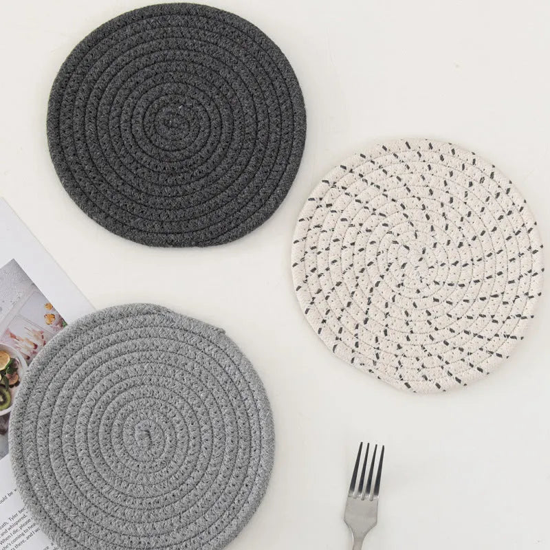 Three round cotton cord coasters in different colours showing 18cm diameter size