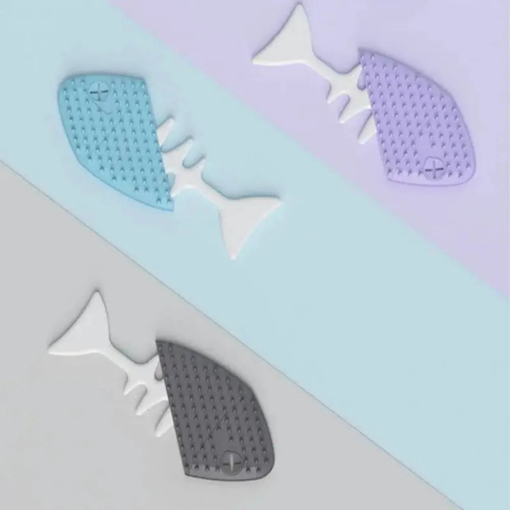 Fishbone-shaped cat brush for indoor pets, available in blue, gray, and purple colours