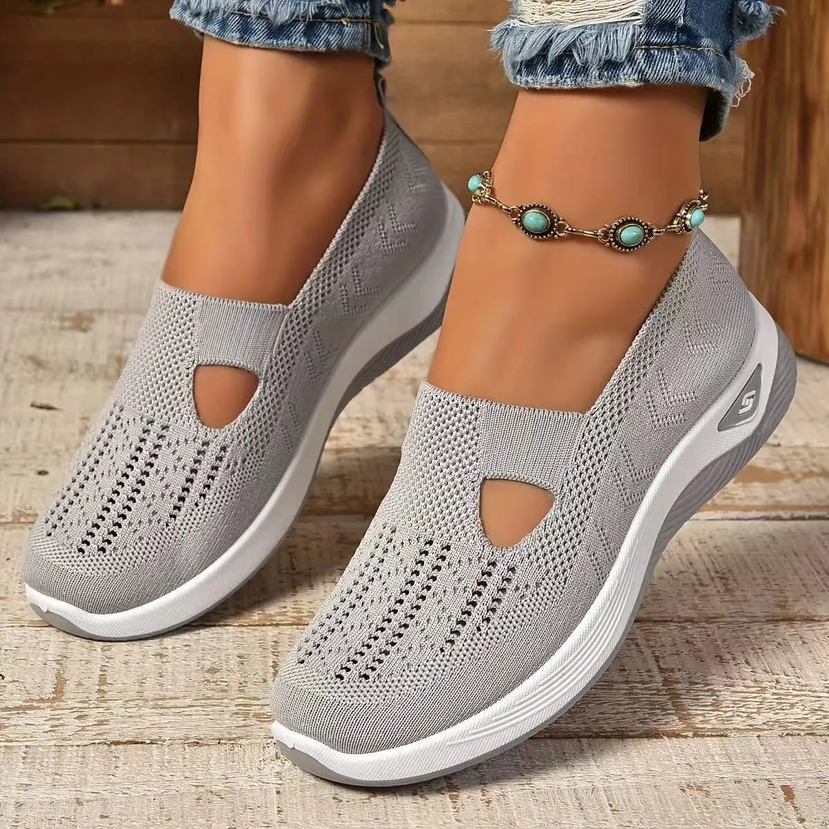 Women's light grey mesh casual flats with a T-strap and round toe on a soft PVC sole.