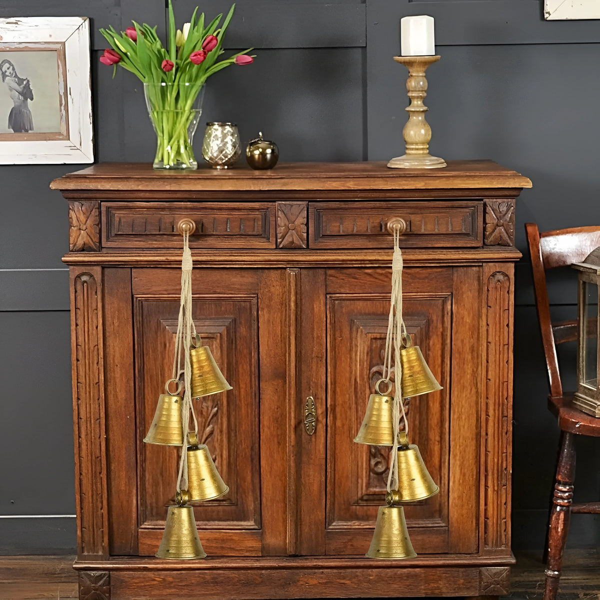 Four retro country handmade metal bells in two colour styles on a rustic wooden background