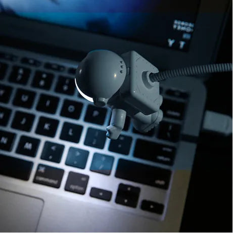 Astronaut USB LED desk lamp with flexible gooseneck and helmet switch on a desk
