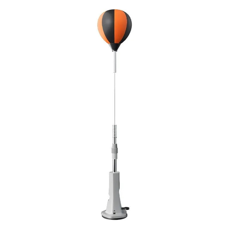 Vertical inflatable speed ball punching target with PU ball, boxing gloves and bandages on a wood floor for home training
