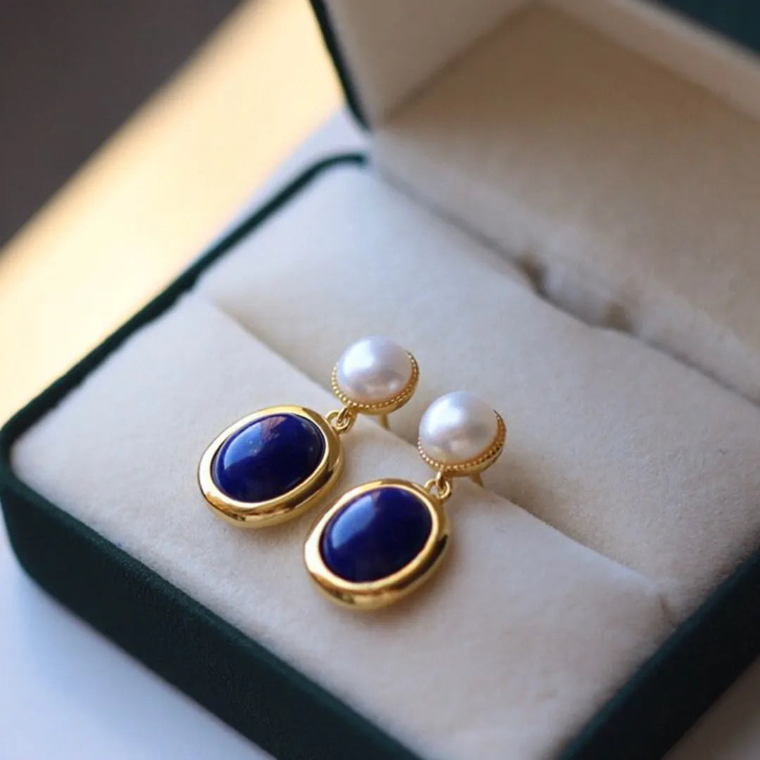A pair of simple sterling silver stud earrings with a lapis lazuli pearl colour and auspicious patterns.